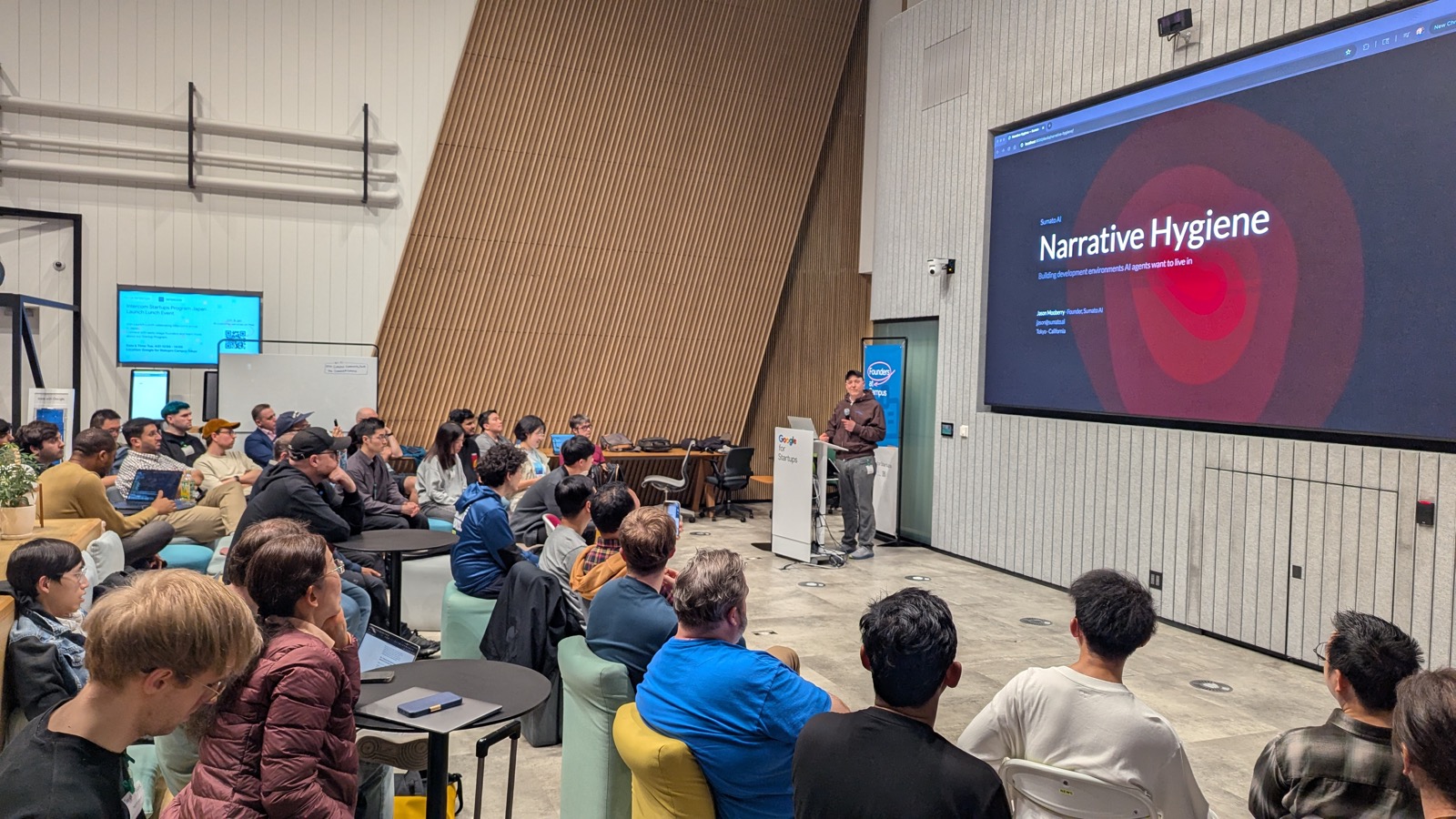Jason Mooberry presenting Narrative Hygiene at Tokyo AI, Google for Startups Campus Shibuya, to a packed audience